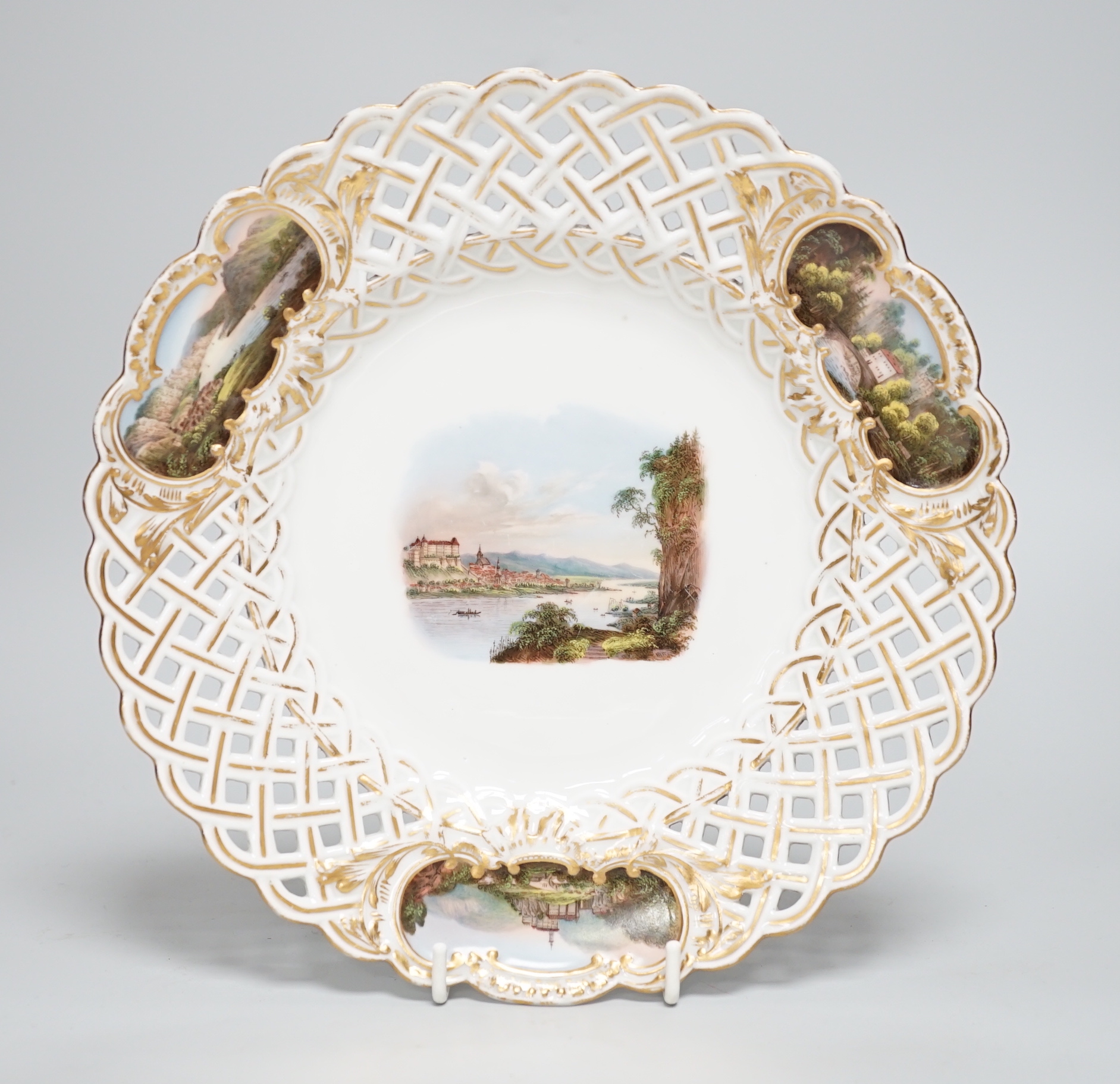 A Meissen topographical reticulated plate, 19th century, painted with named views; Pirna, Wehlstadtel, Weefenstein and Die Lochmukle, 24cm